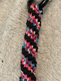 Multicolored braided cord on a textured gray background