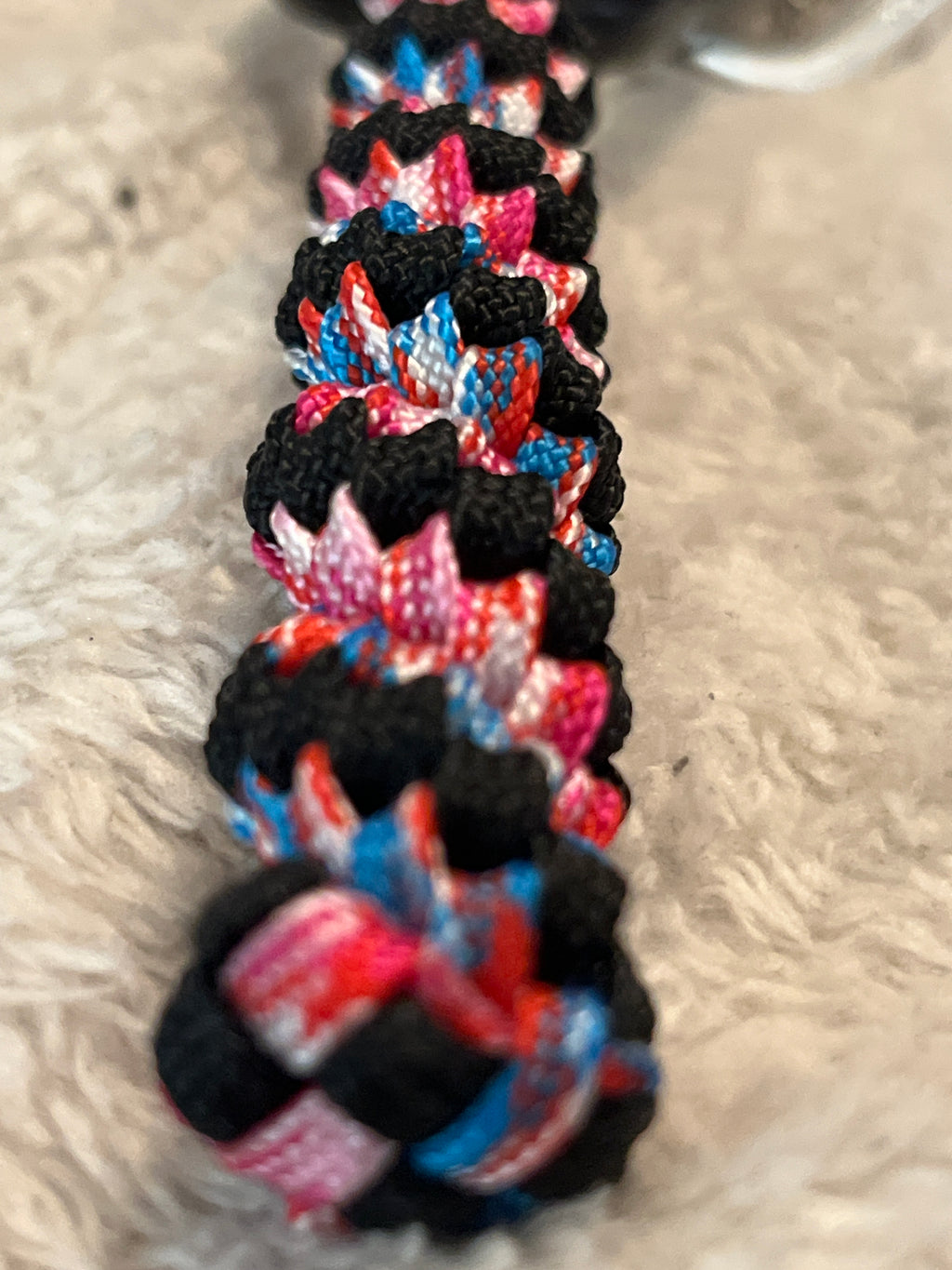 Colorful braided bracelet on a textured surface